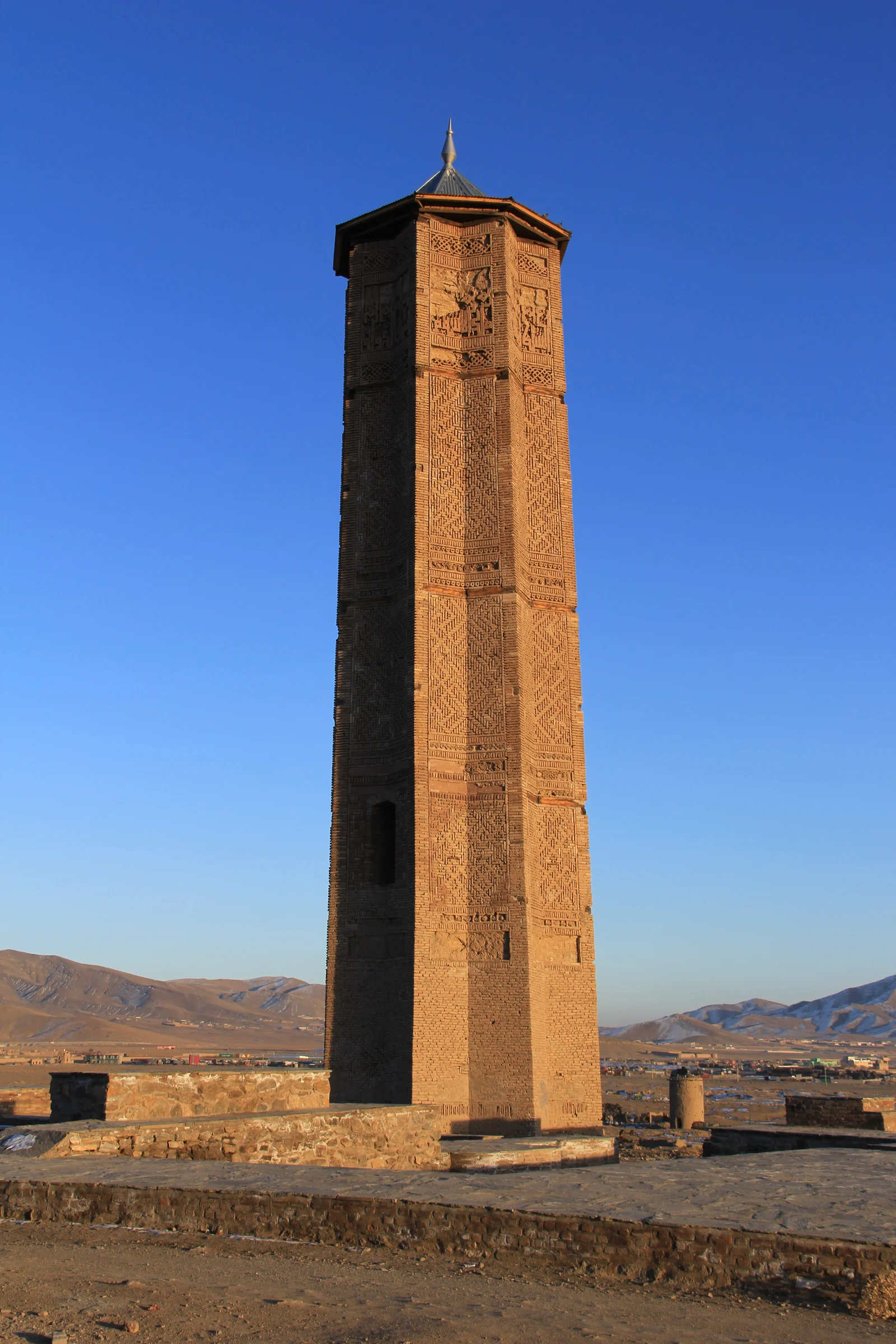 Historic brick minaret rising above the plain in Ghazni.