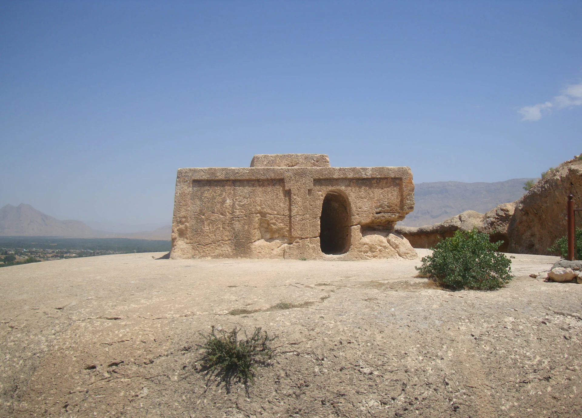 The rock-cut monument at Takht-e Rostam in Samangan under a blue sky.